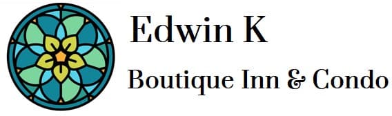 Logo of Edwin K Boutique Inn & Condo featuring a stylized floral design.